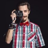 portrait-of-a-cheerful-photographer-in-studio-PRHG57X-Custom.jpg